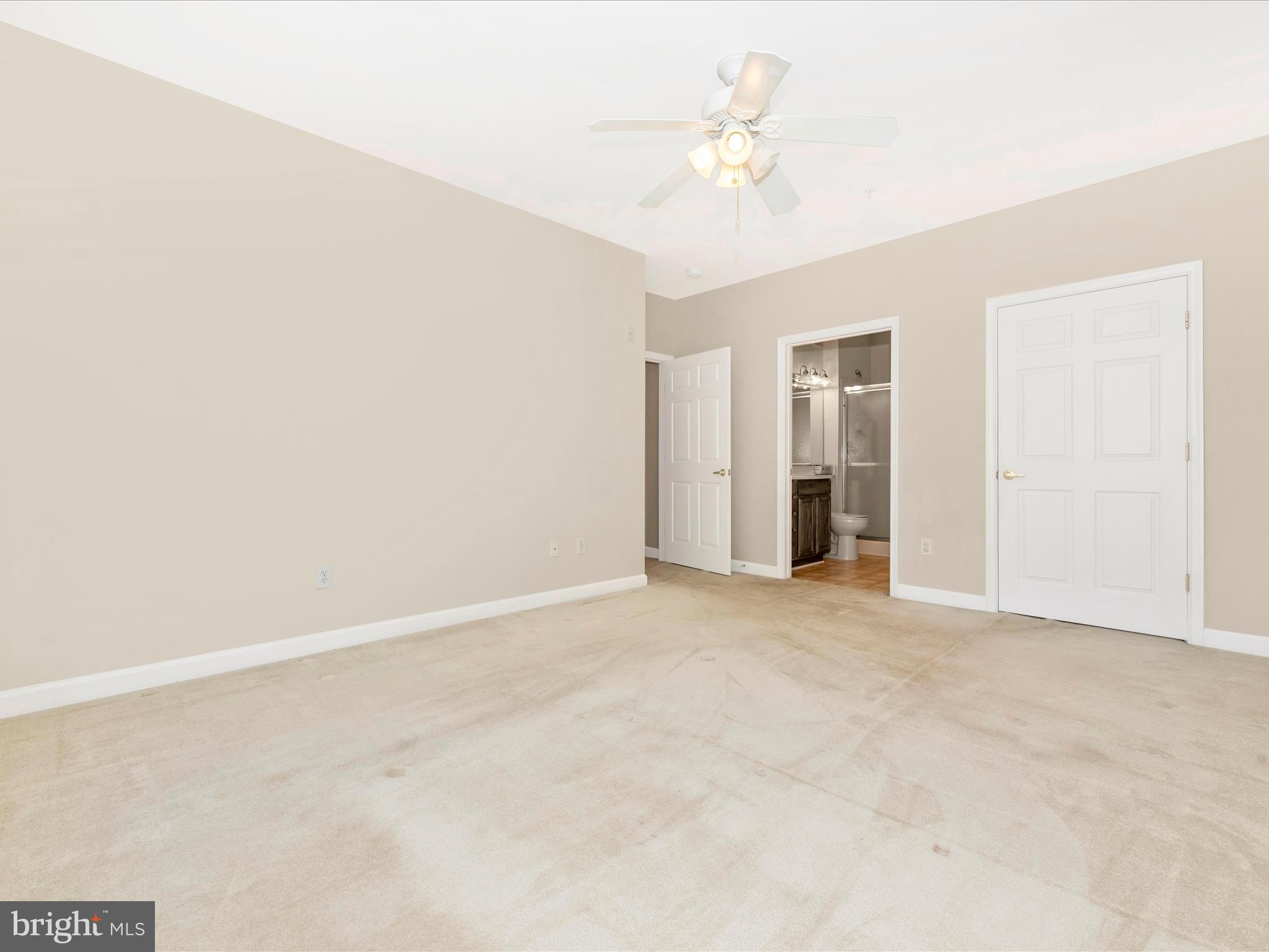 120 Burgess Hill Way, Unit 207 Frederick, MD 21702 - Photo 29 of 67 an empty room with a chandelier fan and closet