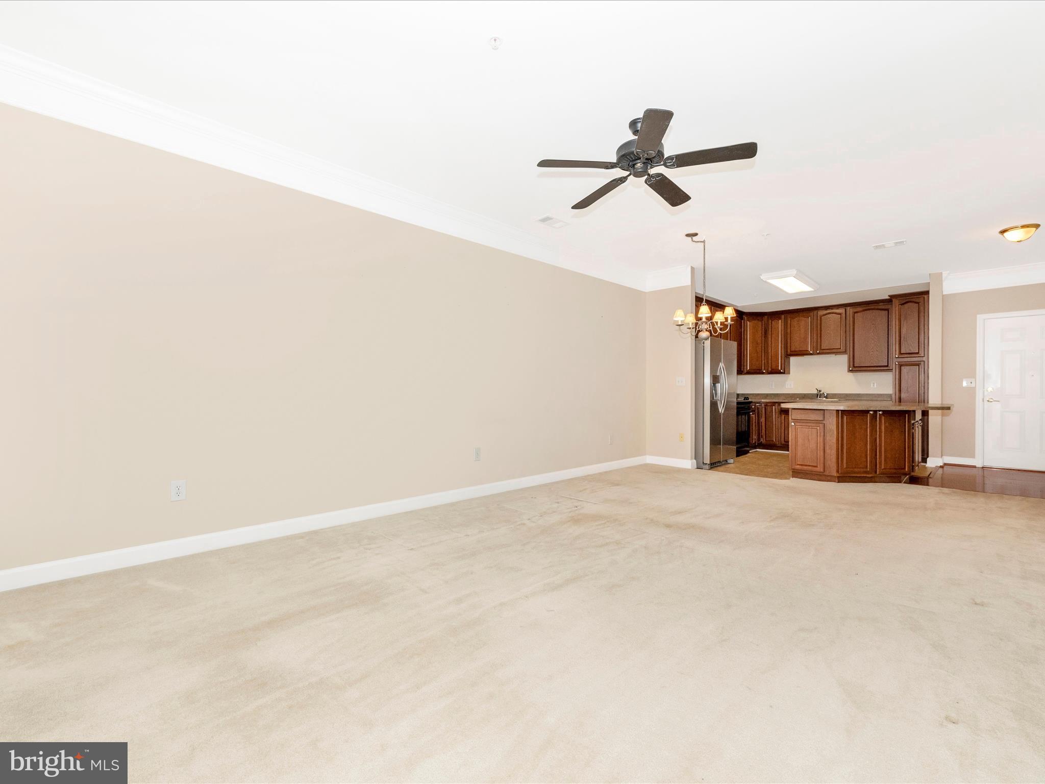120 Burgess Hill Way, Unit 207 Frederick, MD 21702 - Photo 9 of 67 a view of empty room with wooden floor and window