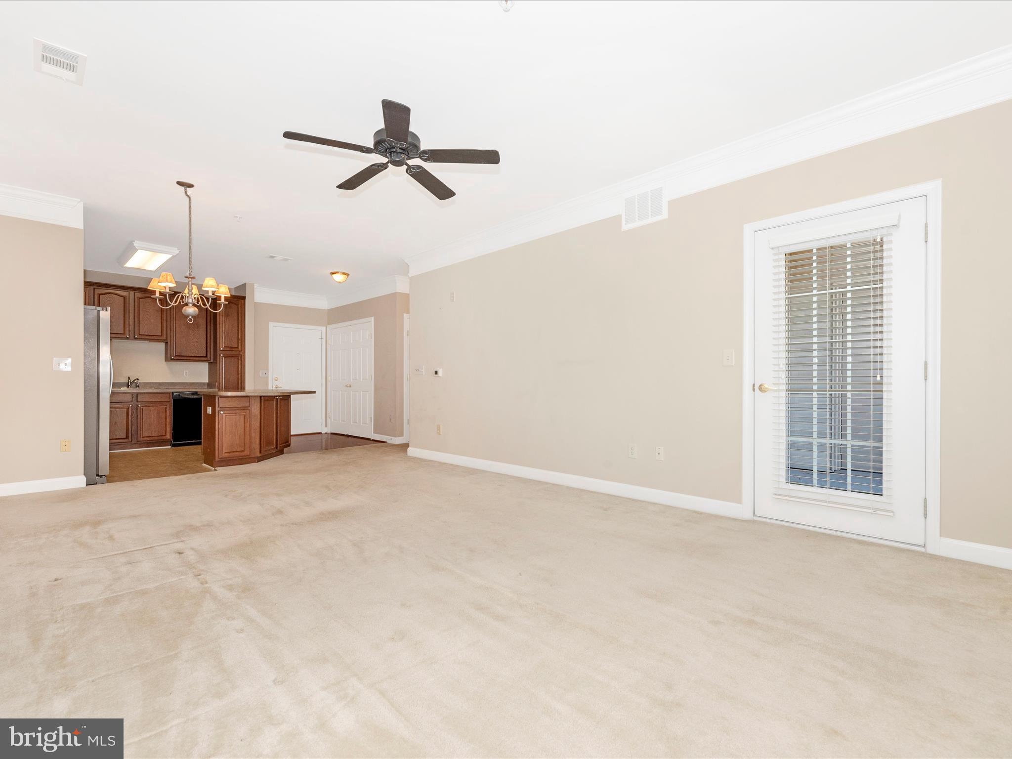 120 Burgess Hill Way, Unit 207 Frederick, MD 21702 - Photo 10 of 67 an empty room with a kitchen space and a window