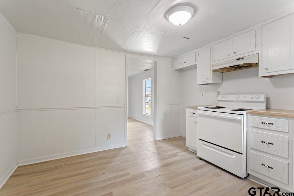 210 Cooper Street Lindale, TX 75771 - Photo 9 of 23 a kitchen with cabinets appliances and wooden floor