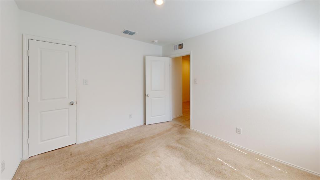 403 Ashbrook Way Princeton, TX 75407 - Photo 12 of 23 Neutral wall color with a light carpeted floor