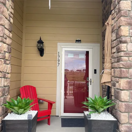 a front view of a house with outdoor seating
