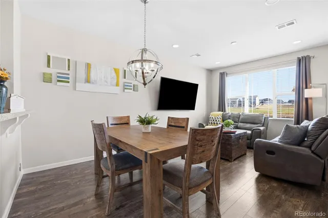 a view of a livingroom with furniture window and wooden floor