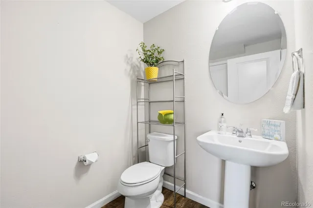 a bathroom with a sink toilet and mirror