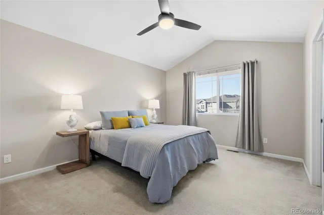 a spacious bedroom with a bed and window