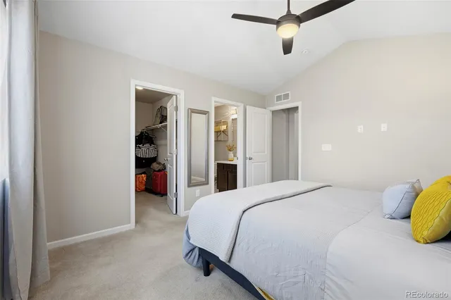 a spacious bedroom with a bed and a walk in closet