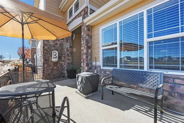 a view of a patio with a table and chairs