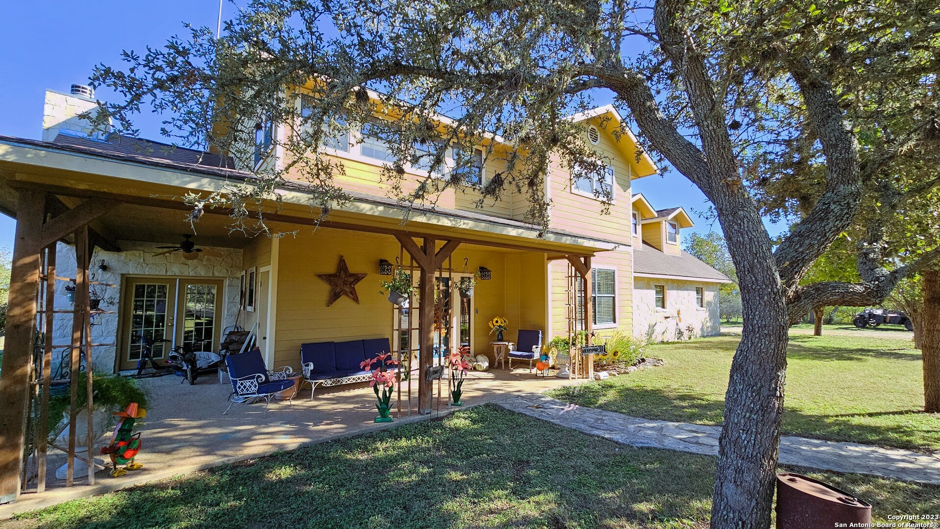 3245 Fm 470 Bandera, TX 78003 - Photo 3 of 58 a view of a chairs and table in the patio next to a yard