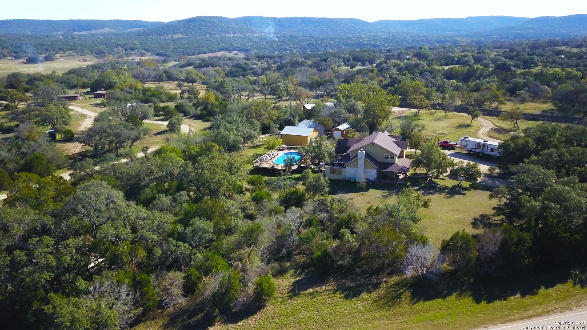 3245 Fm 470 Bandera, TX 78003 - Photo 8 of 58 an aerial view of lake residential house and swimming pool