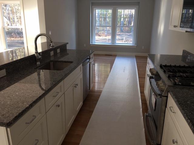 17 Alma Road Mashpee, MA 02649 - Photo 10 of 21 a kitchen with granite countertop a sink stove and cabinets