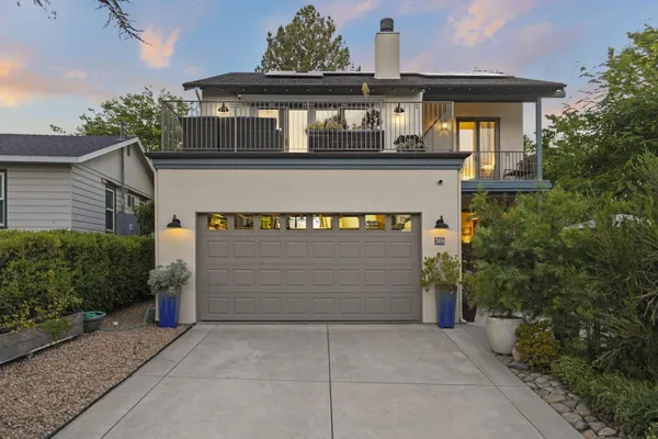 a front view of a house with garden