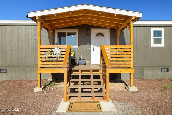 a view of a two chairs in the patio