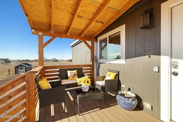 a backyard of a house with barbeque oven table and chairs