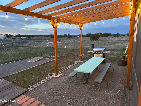 a kitchen with stainless steel appliances kitchen island granite countertop a refrigerator a stove a sink dishwasher with a dining table and chairs