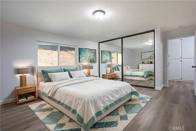 a bedroom with a large bed and a large window