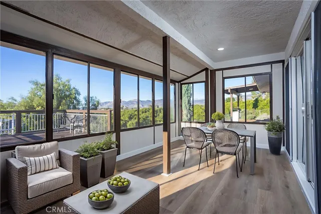 a living room with furniture and floor to ceiling windows