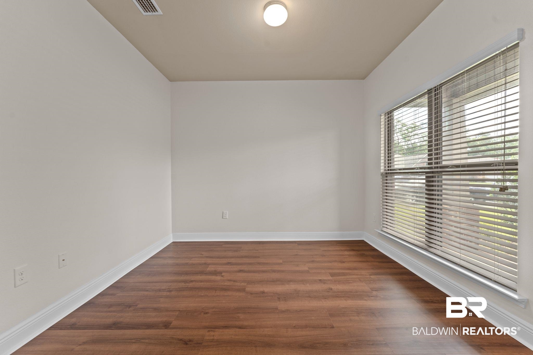 1464 Surrey Loop Foley, AL 36535 - Photo 7 of 24 Unfurnished room featuring wood finished floors