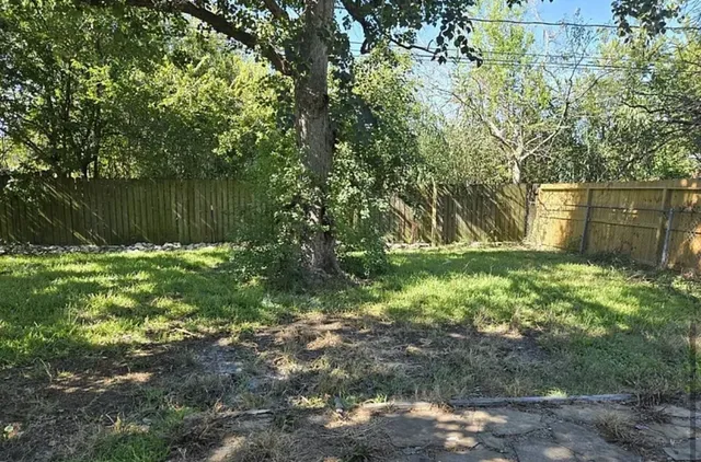 a backyard of a house with lots of green space