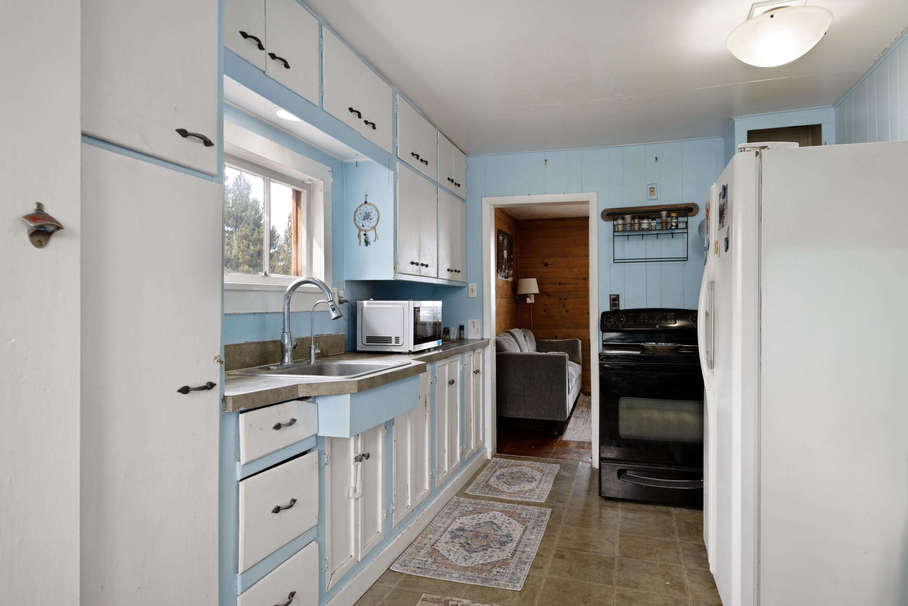 243 West Adams Avenue Sisters, OR 97759 - Photo 5 of 19 a kitchen with a refrigerator and a sink