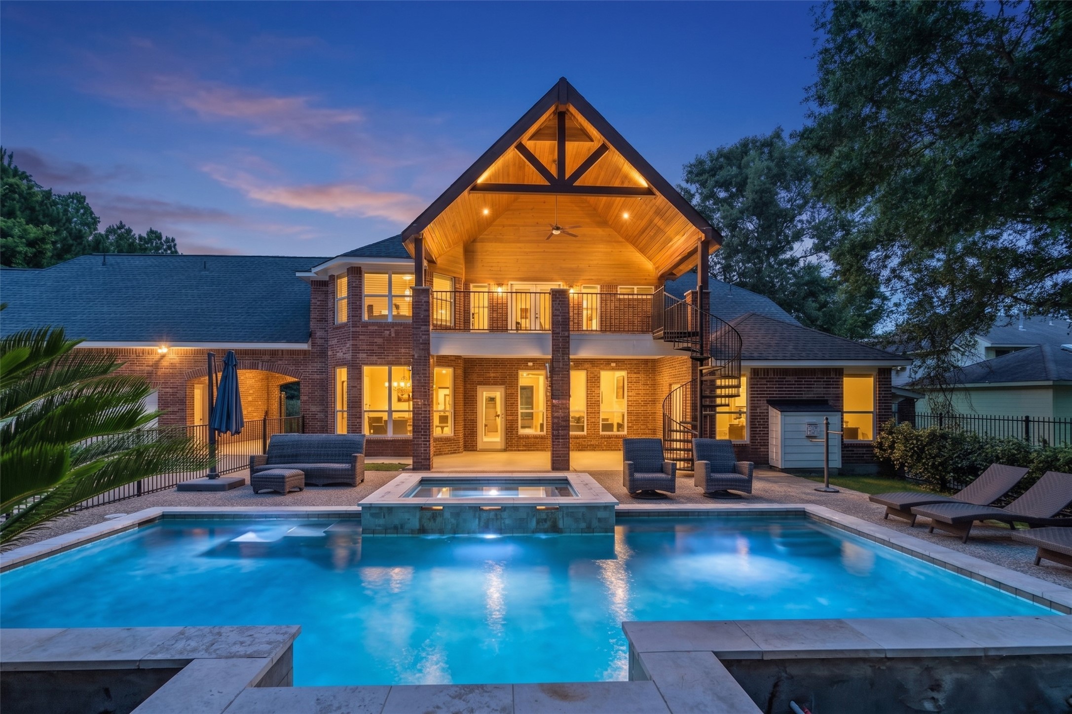 2302 Legends Shore Drive Spring, TX 77386 - Photo 47 of 48 Stunning backyard oasis featuring a sparkling pool, covered outdoor living area, and beautiful evening ambiance.