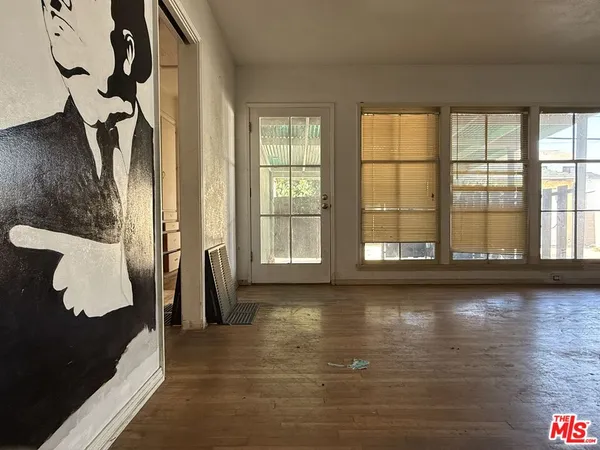 a view of a room with wooden floor and floor to ceiling window