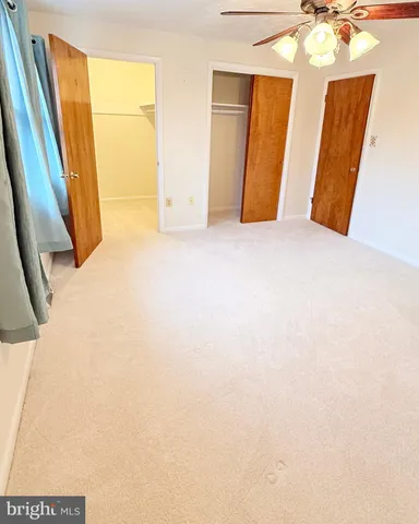 a view of an ocean with a floor to ceiling window next to a yard