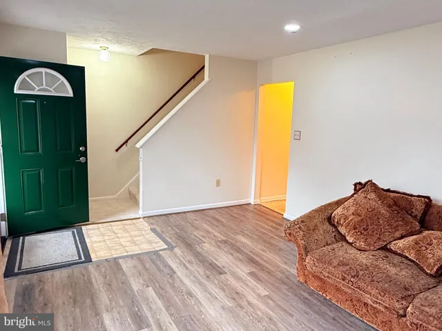 a bedroom with a bed and a wooden floor