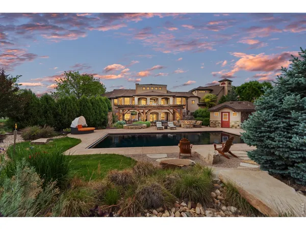 a swimming pool with outdoor seating and yard