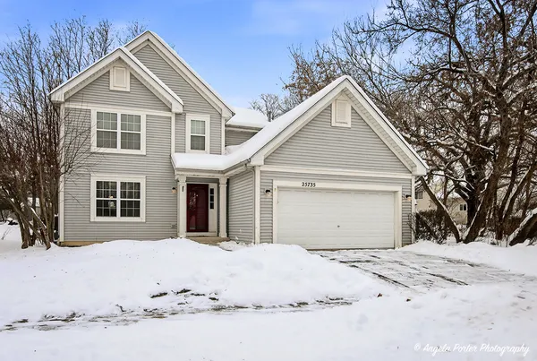 a view of a white house with a yard covered with snow in front of house