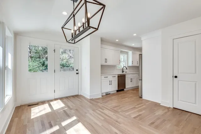 a view of empty room with wooden floor and window
