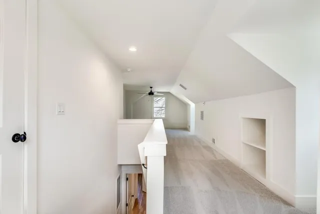 a view of a hallway with windows