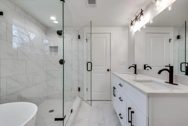 a white bath tub sitting in a bathroom next to a window