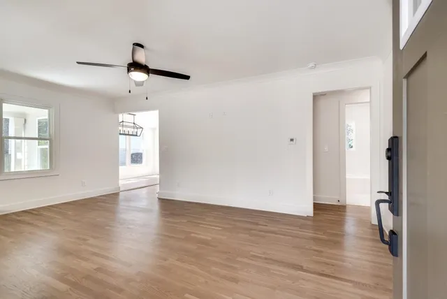 wooden floor in an empty room with a window