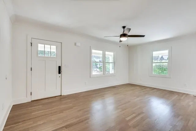 a view of a room with wooden floor and a window