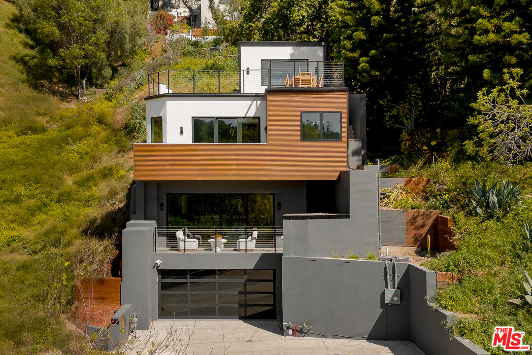 512 Rustic Drive Los Angeles, CA 90065 - Photo 2 of 53 a view of house with a yard outdoor seating and covered with tall trees
