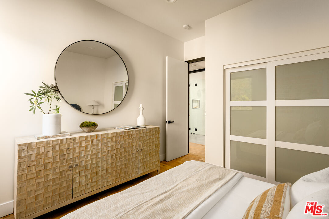 512 Rustic Drive Los Angeles, CA 90065 - Photo 22 of 53 a bedroom with a bed a mirror and a potted plant
