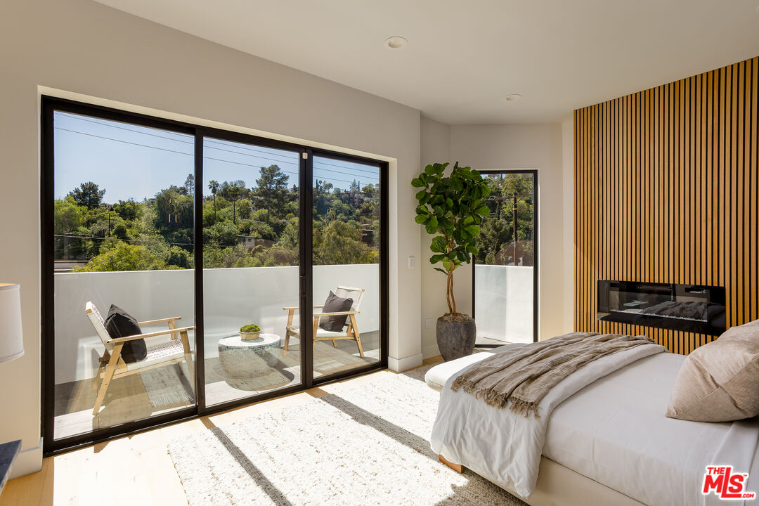 512 Rustic Drive Los Angeles, CA 90065 - Photo 29 of 53 a bedroom with a bed and glass door