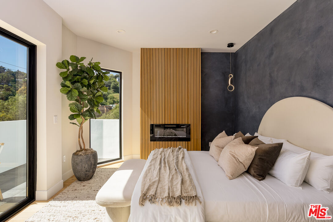 512 Rustic Drive Los Angeles, CA 90065 - Photo 30 of 53 a bedroom with bed and a potted plant