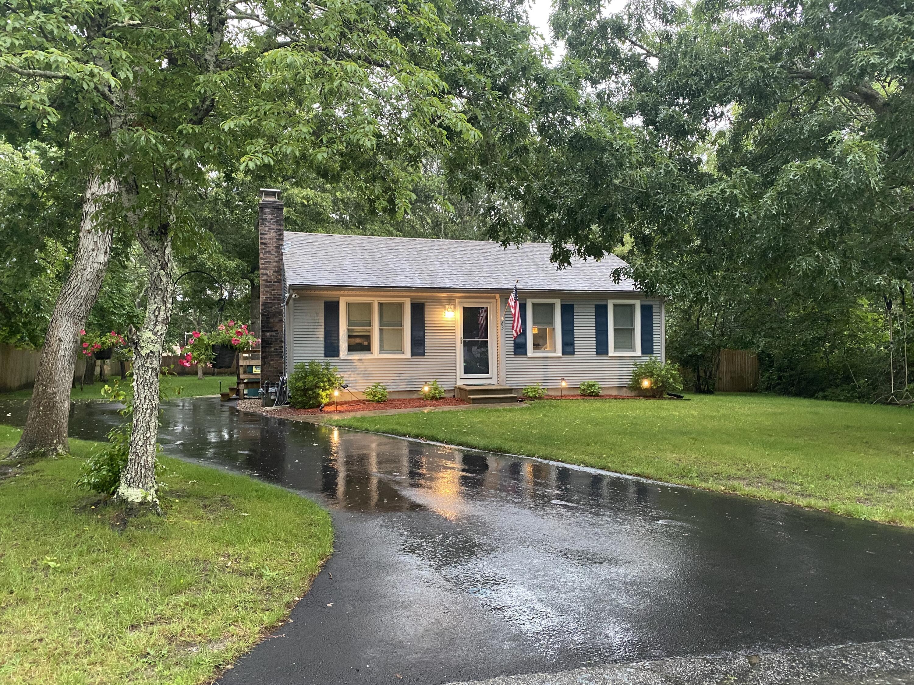 65 Kelley Road Hyannis, MA 02601 - Photo 1 of 38 a front view of a house with yard and green space