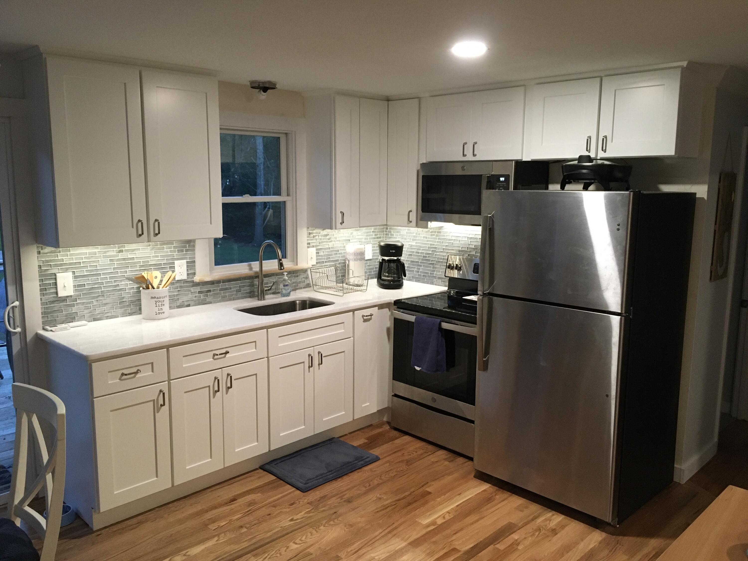 65 Kelley Road Hyannis, MA 02601 - Photo 8 of 38 a kitchen with a refrigerator sink and cabinets