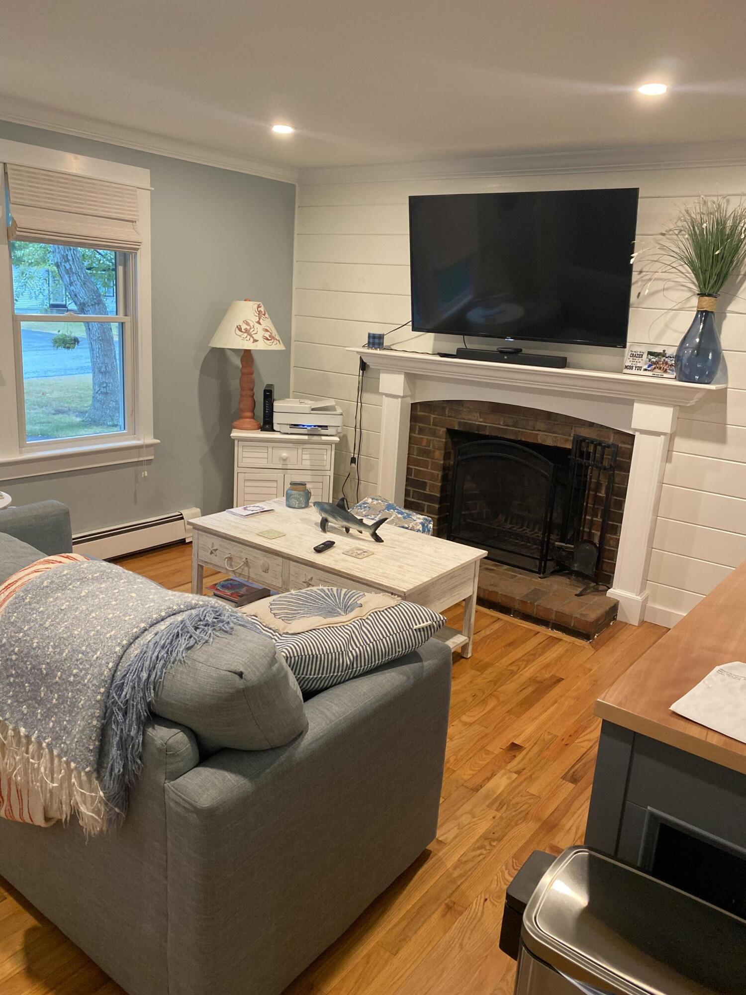 65 Kelley Road Hyannis, MA 02601 - Photo 9 of 38 a living room with furniture a flat screen tv and a fireplace