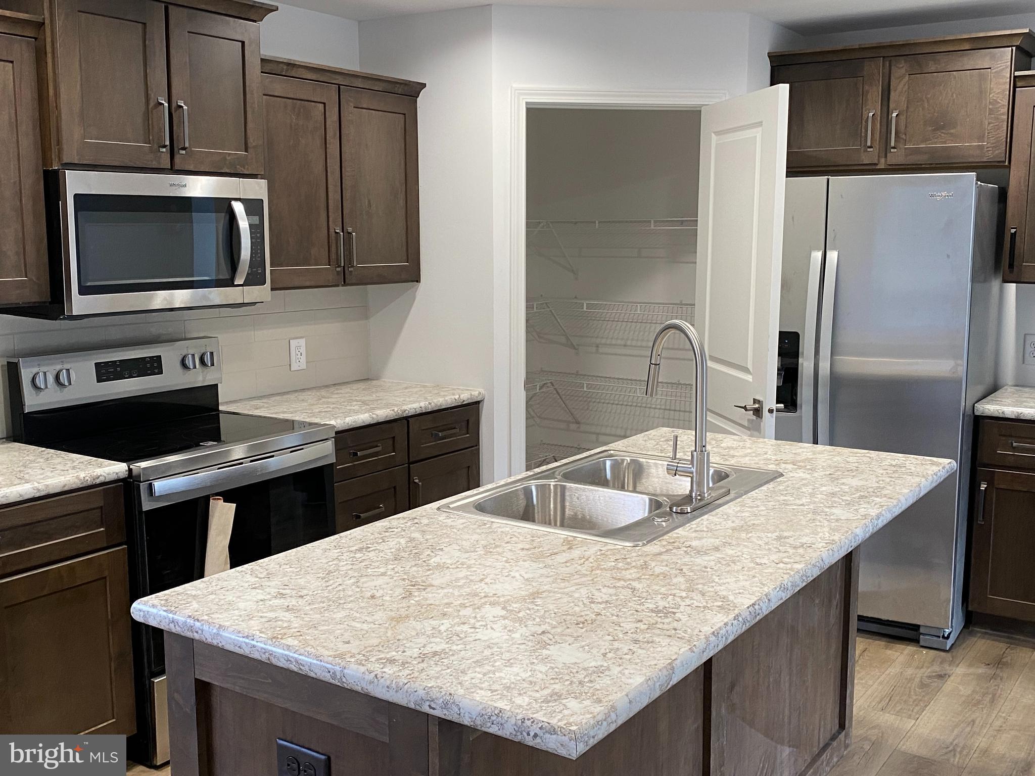 1751 Hilltown Road Biglerville, PA 17307 - Photo 5 of 15 a kitchen with stainless steel appliances granite countertop a sink microwave and cabinets