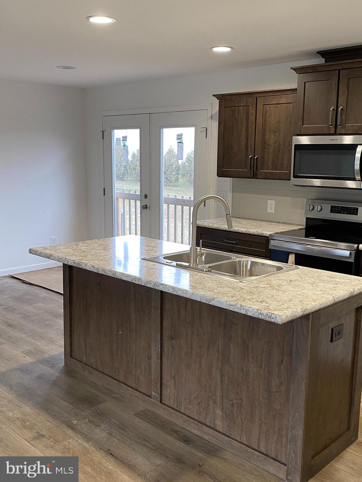 1751 Hilltown Road Biglerville, PA 17307 - Photo 6 of 15 a kitchen with stainless steel appliances granite countertop a sink a stove and a microwave
