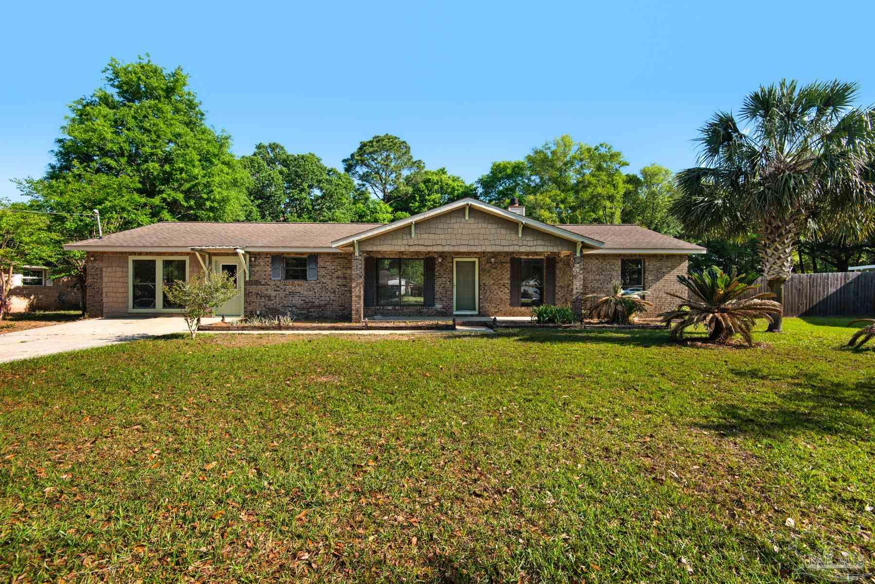 5804 Gulf Road Milton, FL 32583 - Photo 1 of 54 a house with swimming pool in front of it