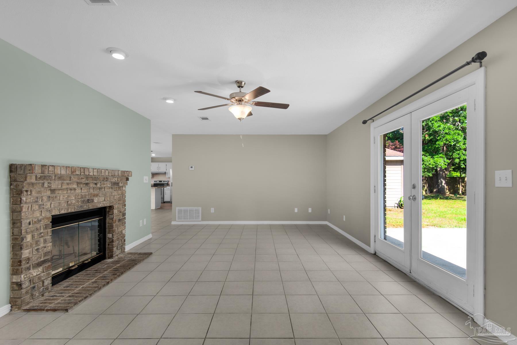 5804 Gulf Road Milton, FL 32583 - Photo 2 of 54 an empty room with windows and fireplace