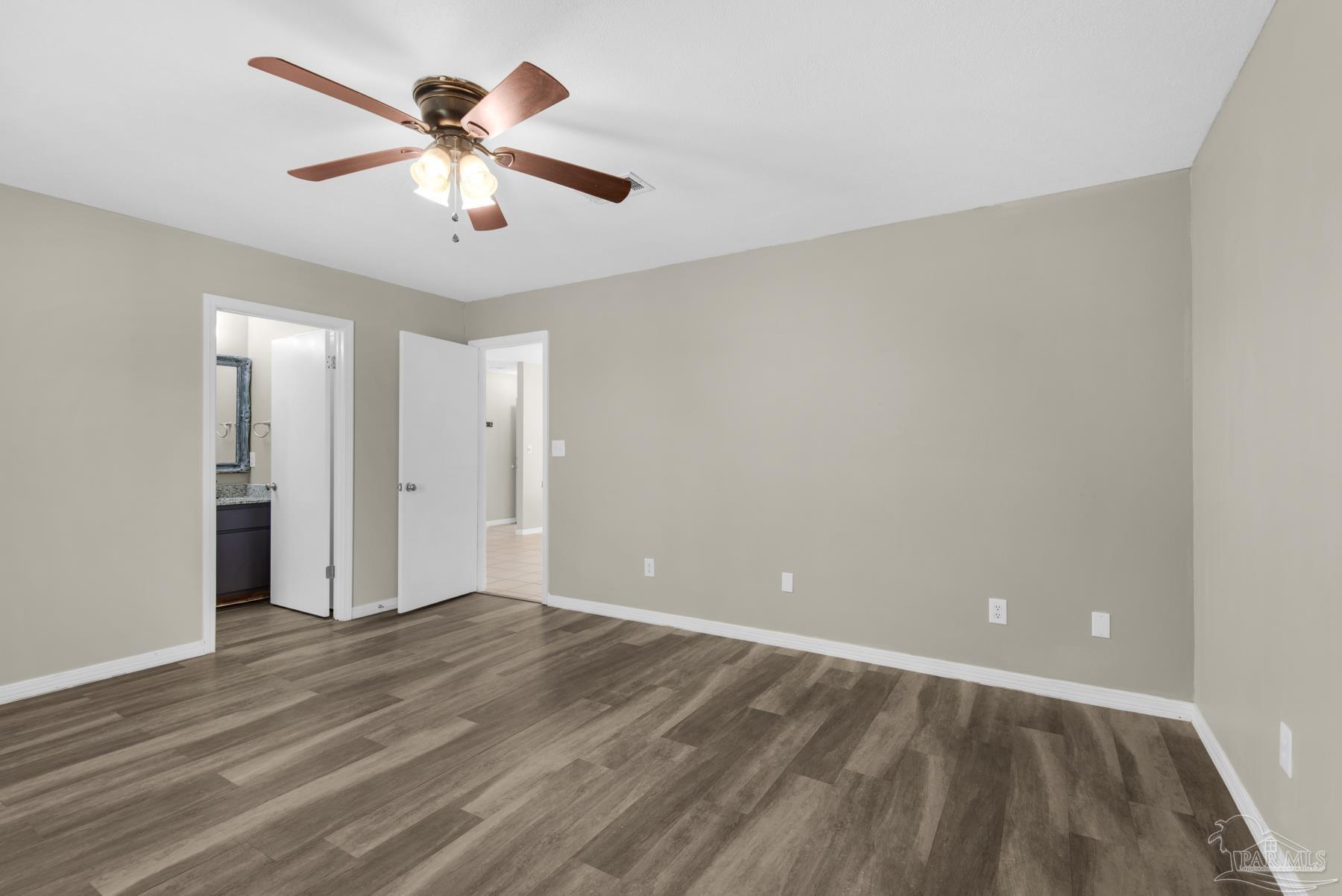 5804 Gulf Road Milton, FL 32583 - Photo 25 of 54 wooden floor in an empty room with a window