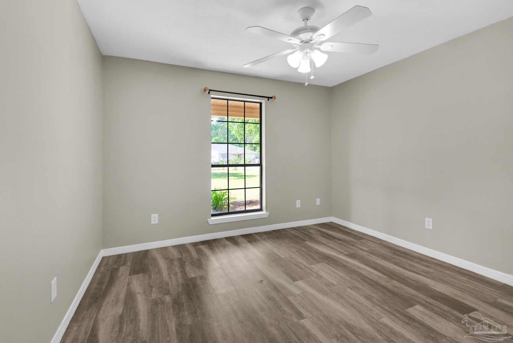 5804 Gulf Road Milton, FL 32583 - Photo 29 of 54 wooden floor in an empty room with a window