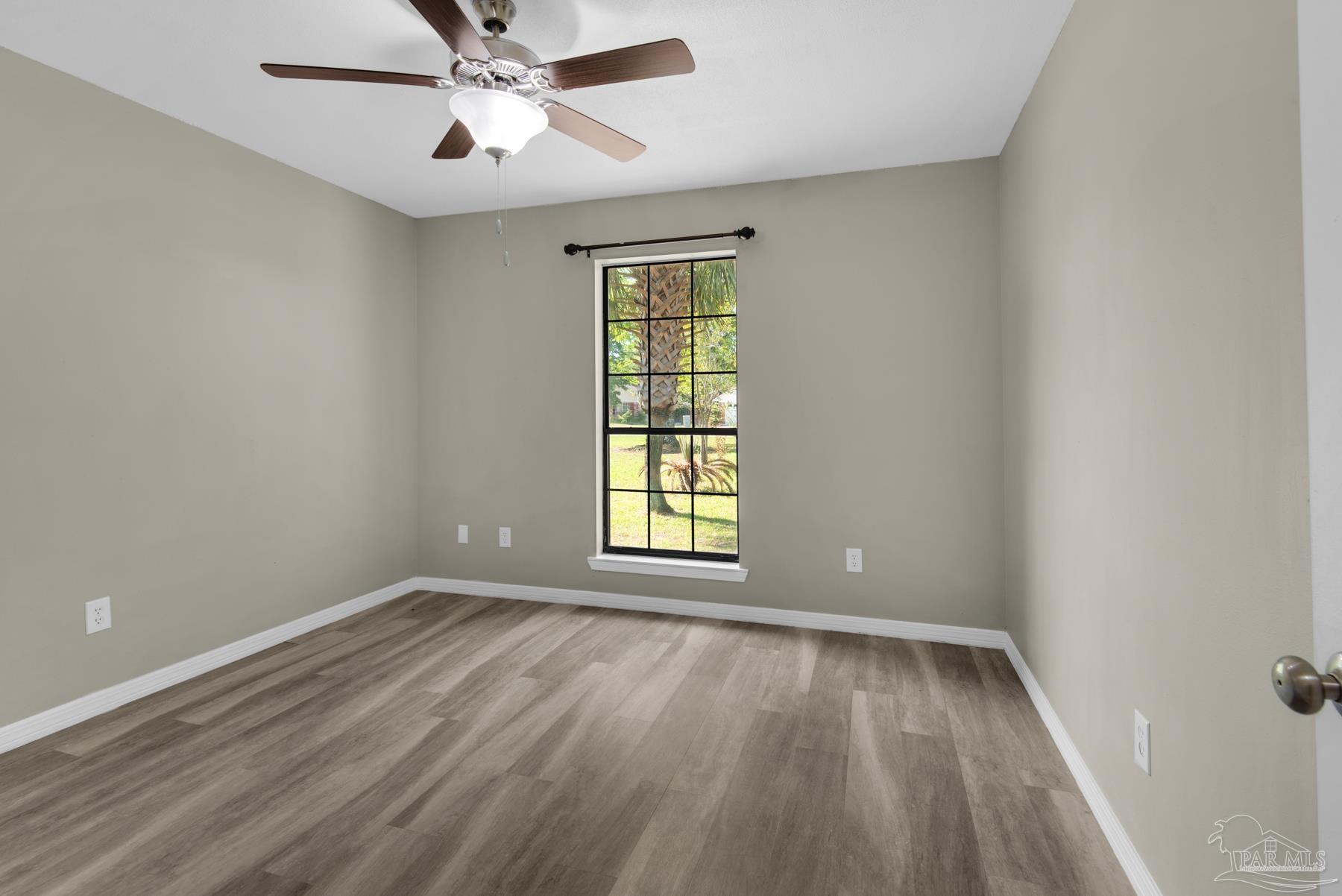 5804 Gulf Road Milton, FL 32583 - Photo 31 of 54 wooden floor in an empty room with a window