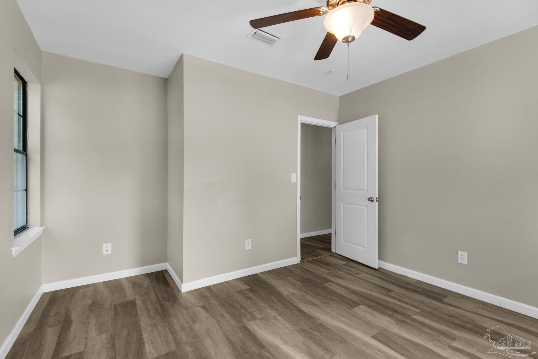 5804 Gulf Road Milton, FL 32583 - Photo 38 of 54 wooden floor in an empty room with a window