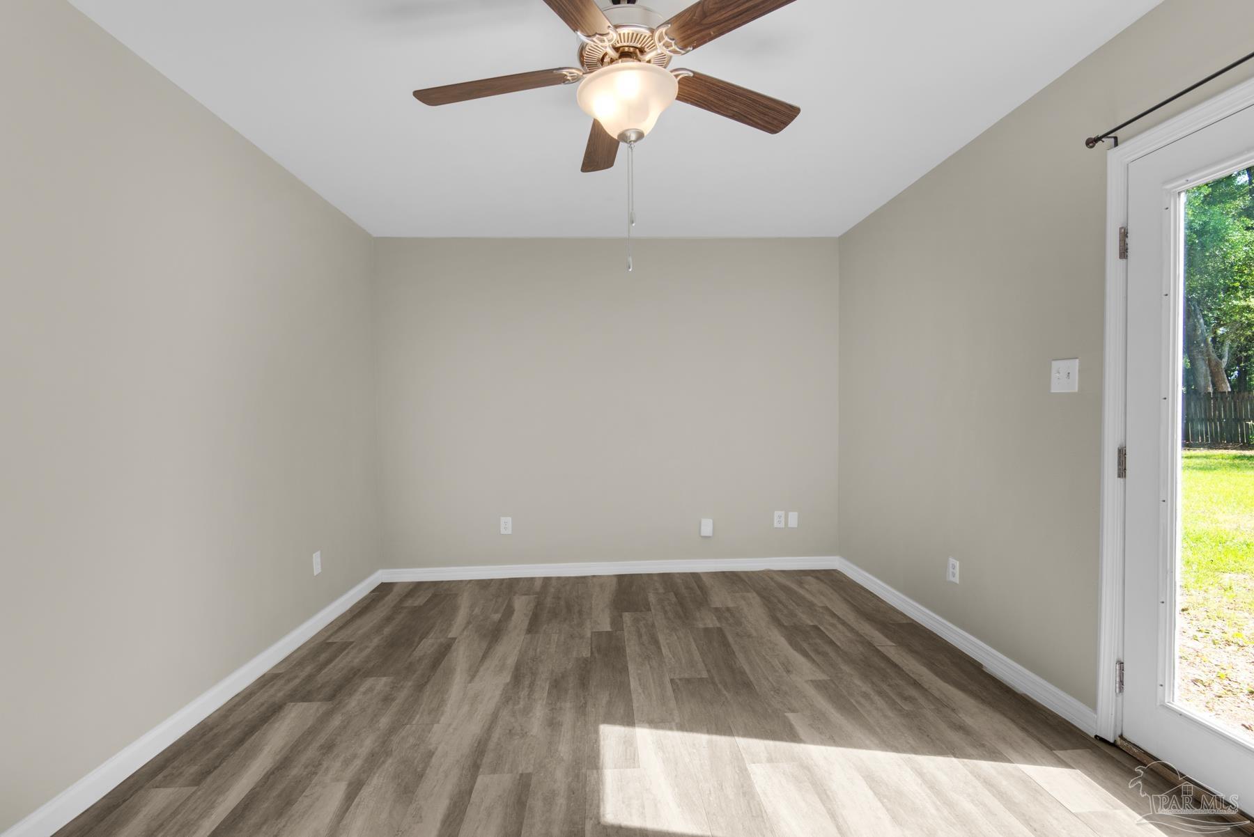 5804 Gulf Road Milton, FL 32583 - Photo 44 of 54 wooden floor in an empty room with a window